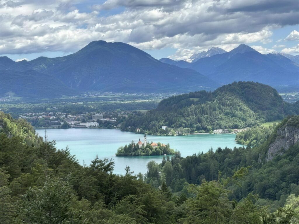 Lake Bled with its island church, seen from the wooded hillside above