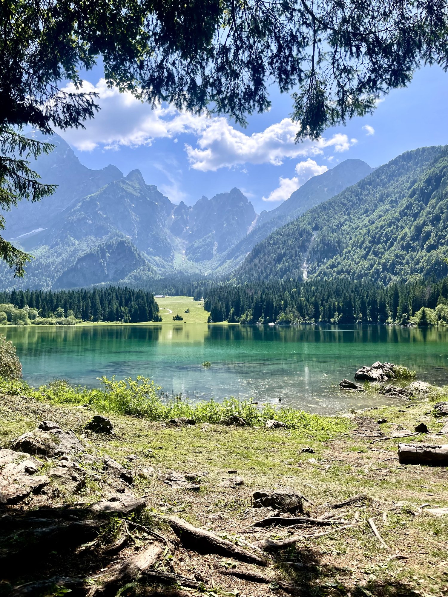 Turquoise alpine lake below the jagged peaks of the Julian Alps